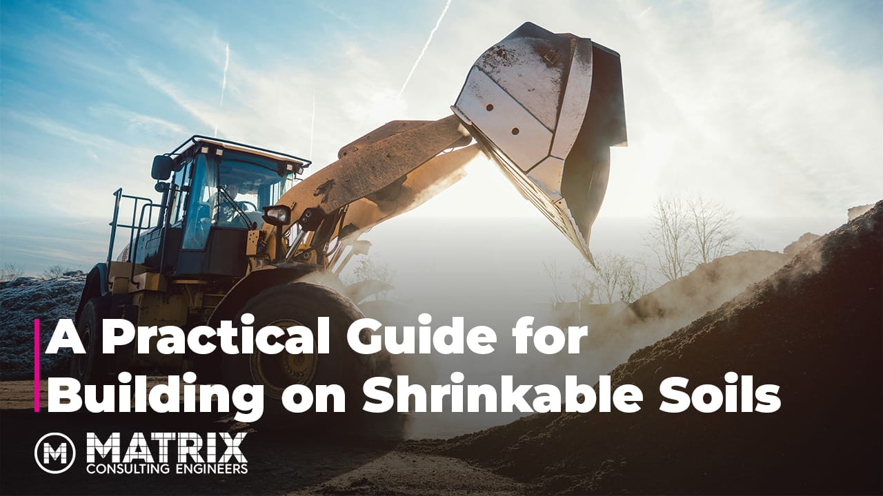 A construction excavator moves soil at a worksite under a clear sky. Text reads: A Practical Guide for Building on Shrinkable Soils. Matrix Consulting Engineers.