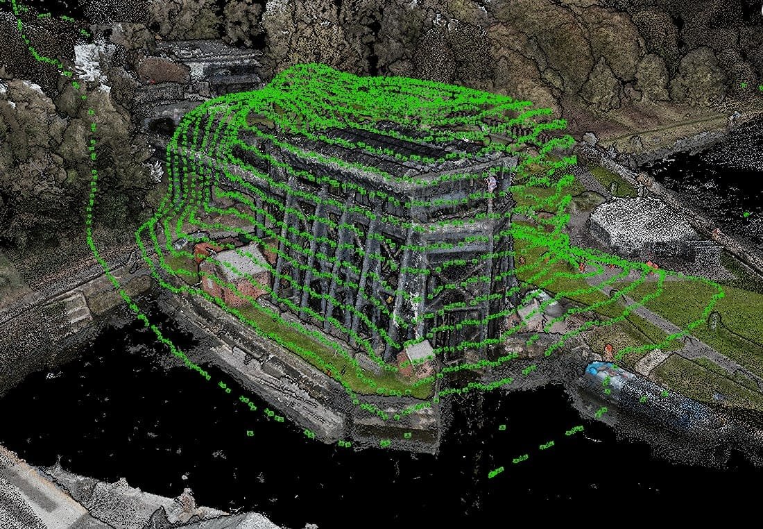 A 3D point cloud image of a riverside building is overlaid with green contour lines, showing topographical mapping around the structure and nearby landscape.